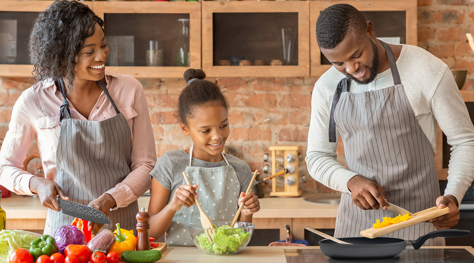 family of 3 cooking together in a kitchen