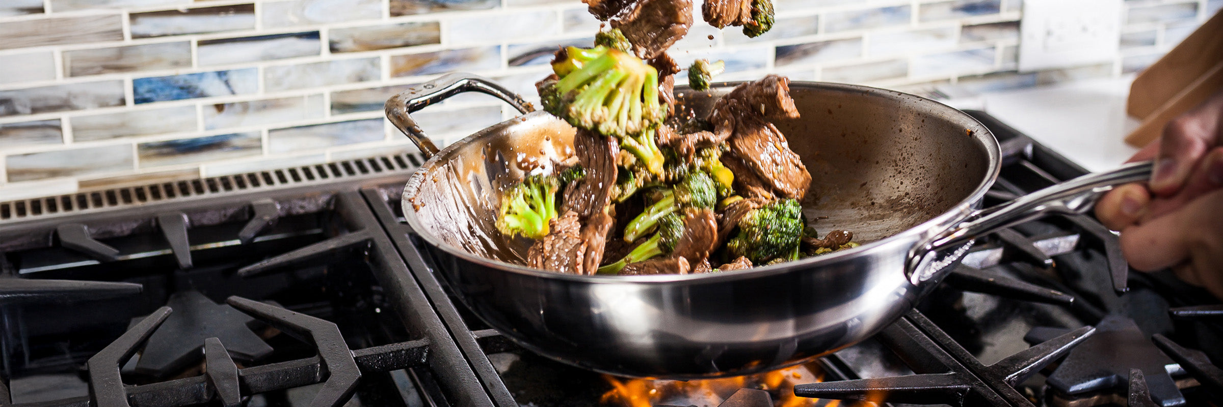 Premium Clad with food inside on gas stove top