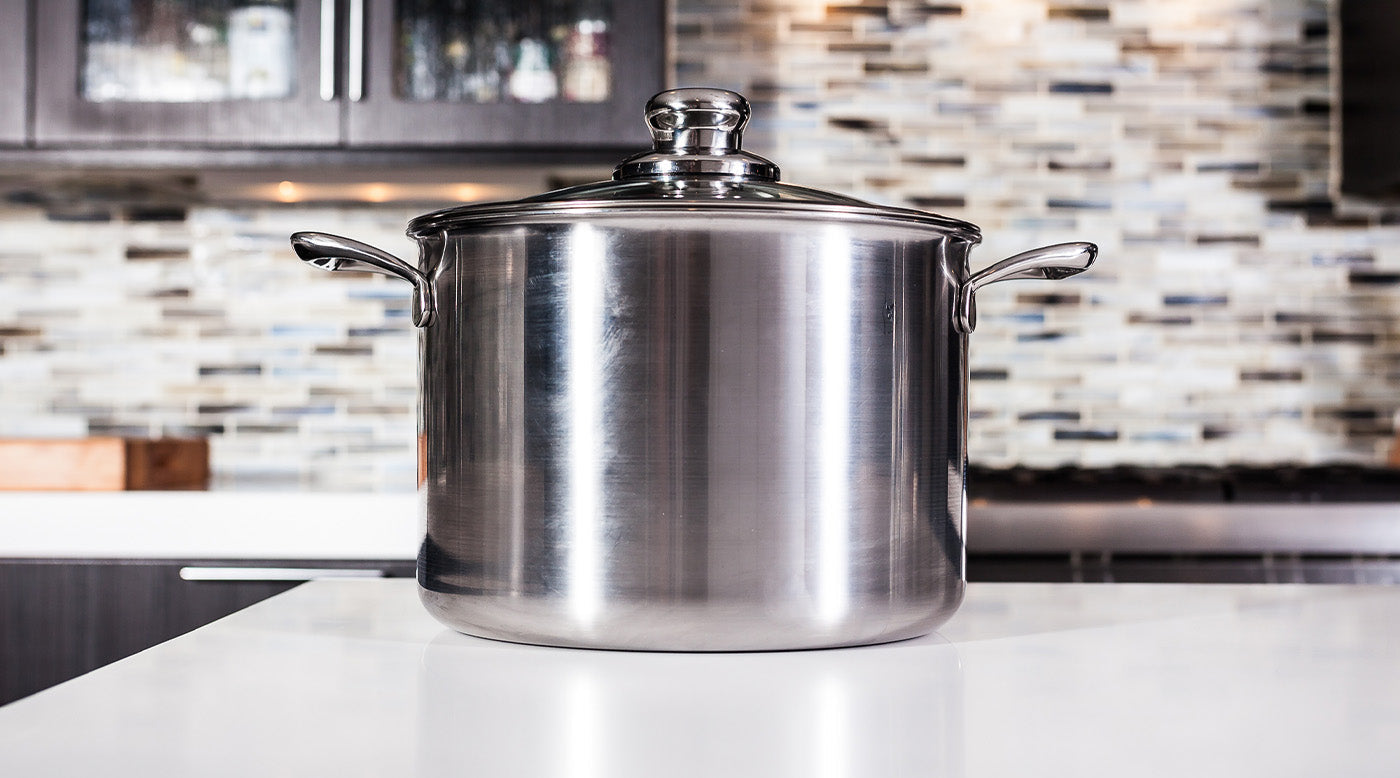 Stainless Steel Soup & Stock Pots with tempered glass lid sitting on a white marble kitchen counter