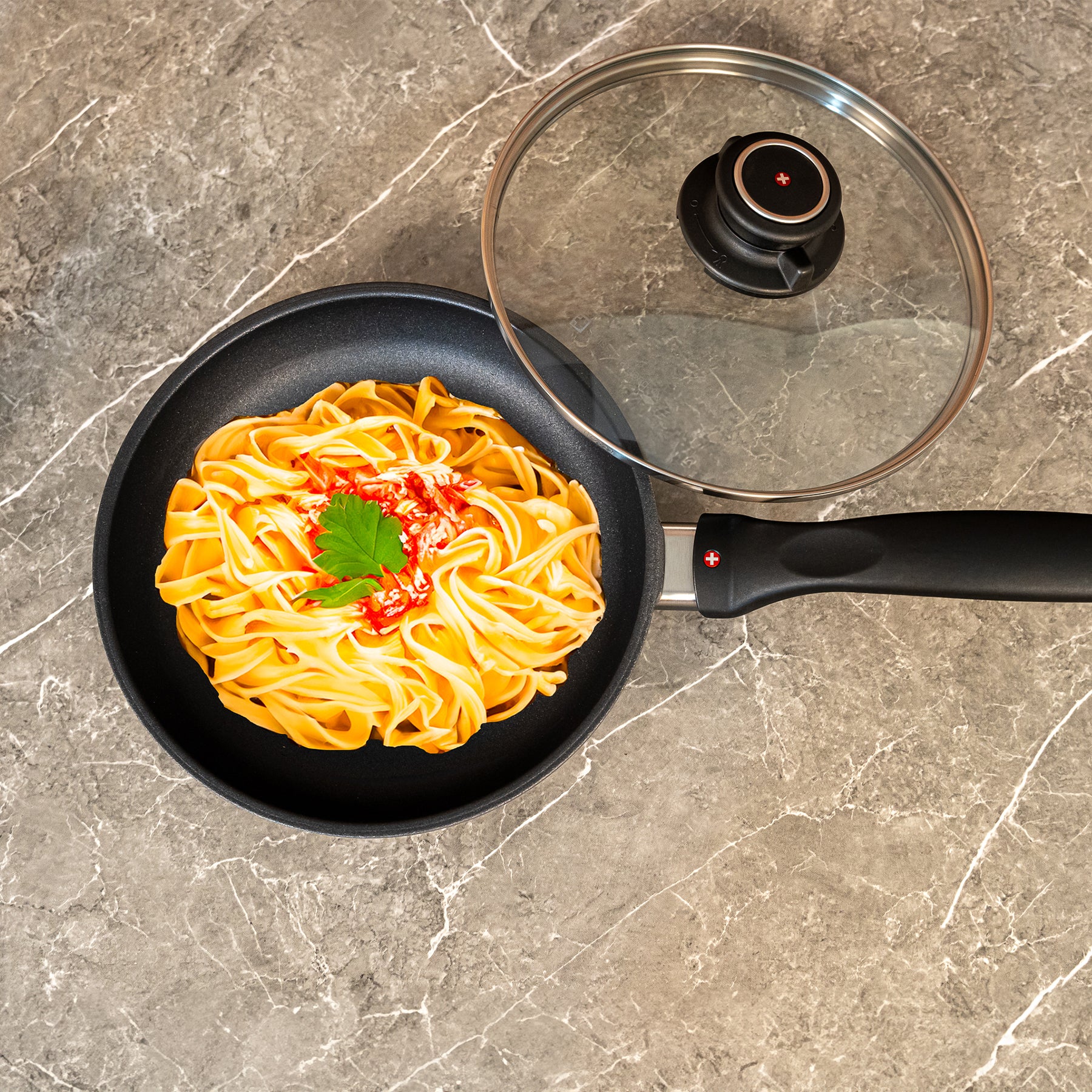 HD Nonstick Fry Pan with Glass Lid in use with pasta on surface
