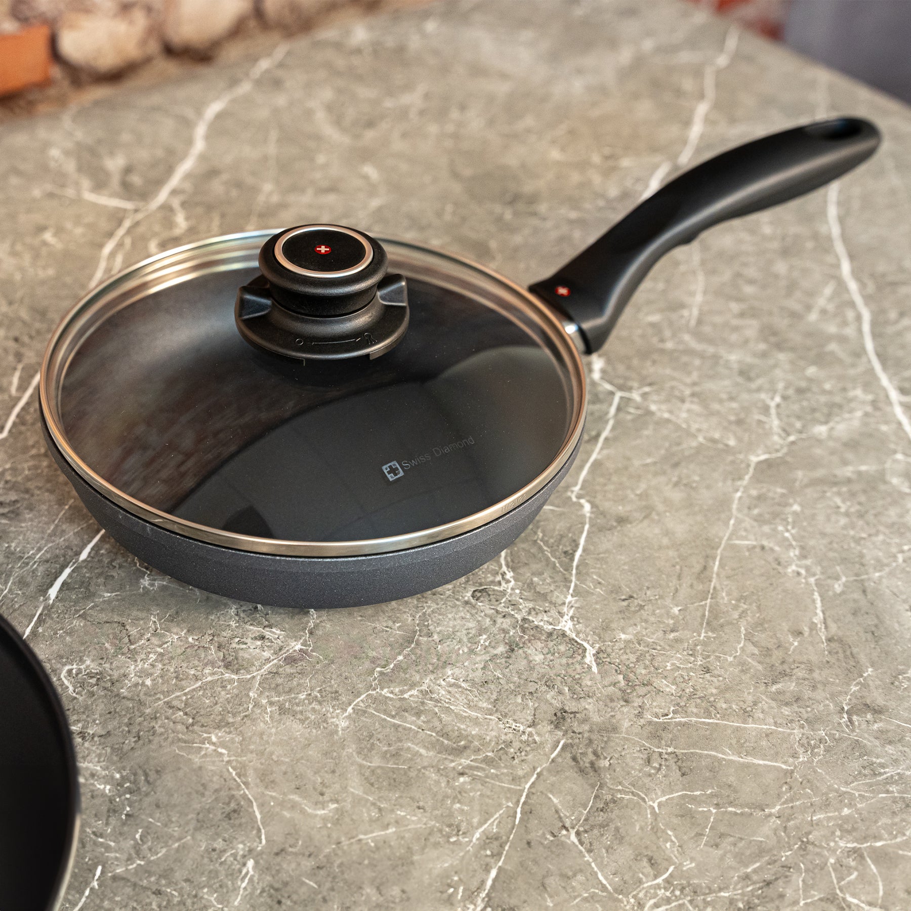HD Nonstick Fry Pan with Glass Lid in use on marble kitchen counter