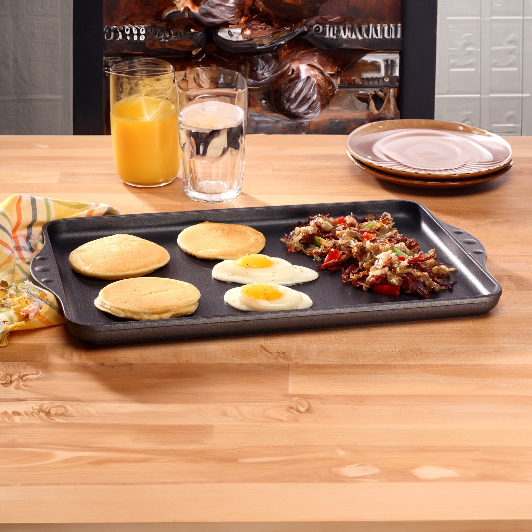HD Nonstick 17" x 11" Double-Burner Griddle in use on wooden table
