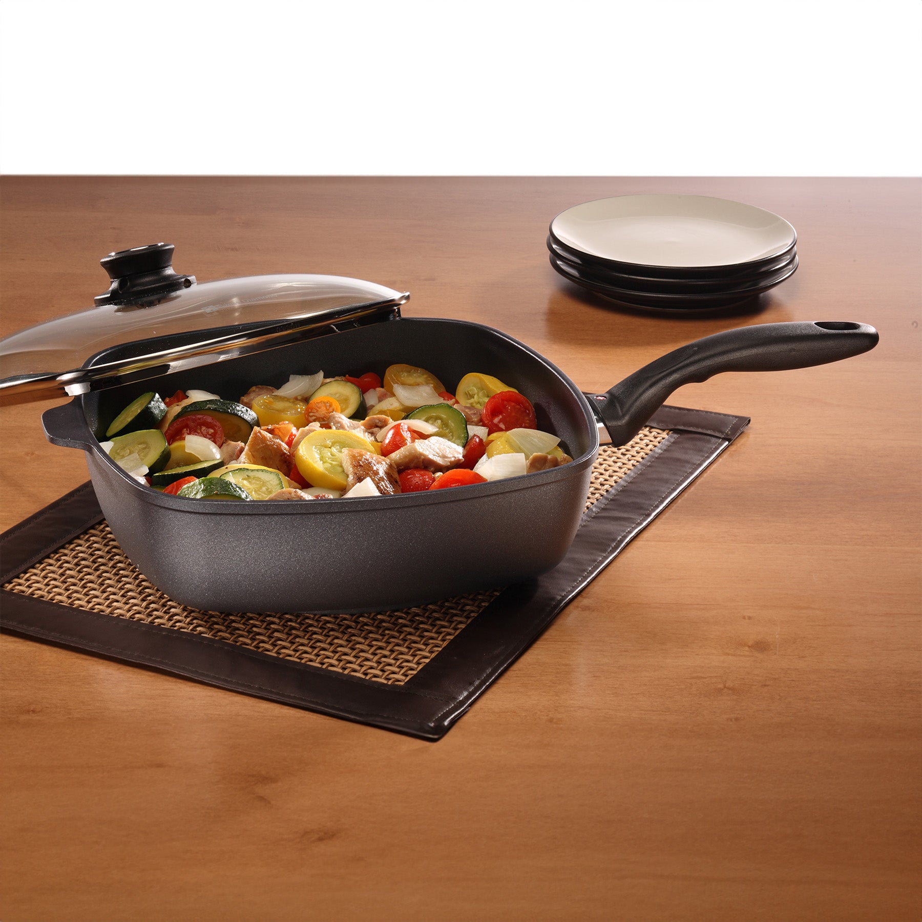 HD Nonstick Square Saute Pan with Glass Lid - Induction in use on wooden dining room table