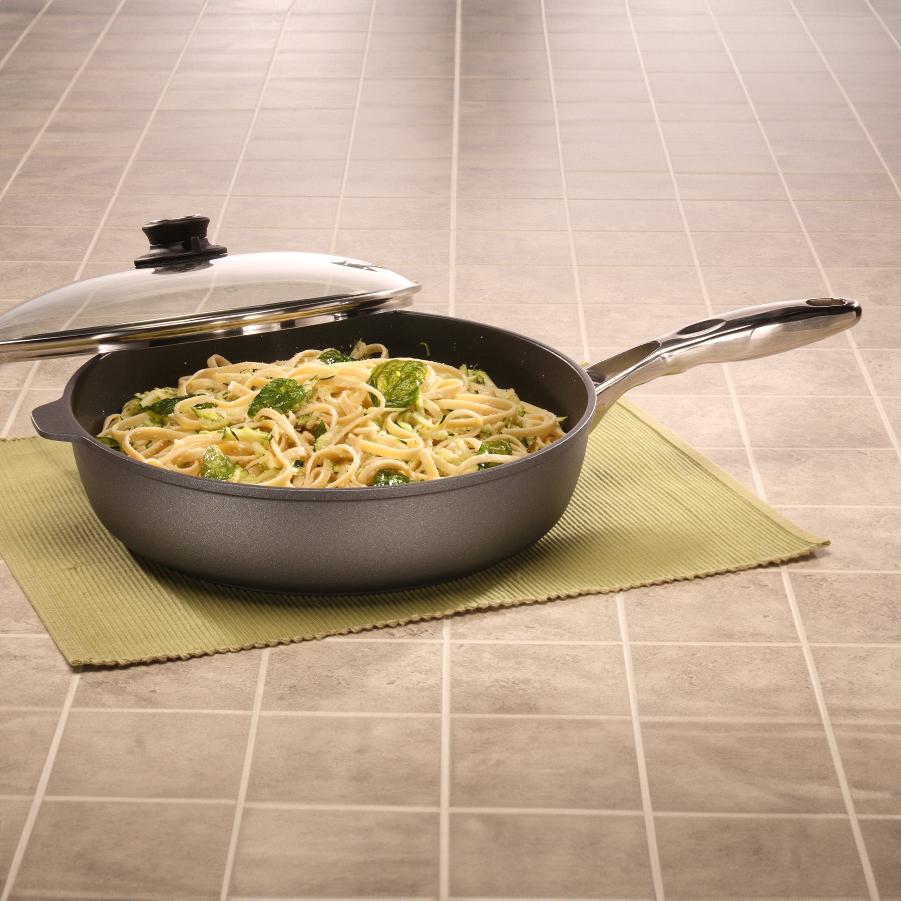 HD Nonstick Saute Pan with Glass Lid in use on kitchen counter