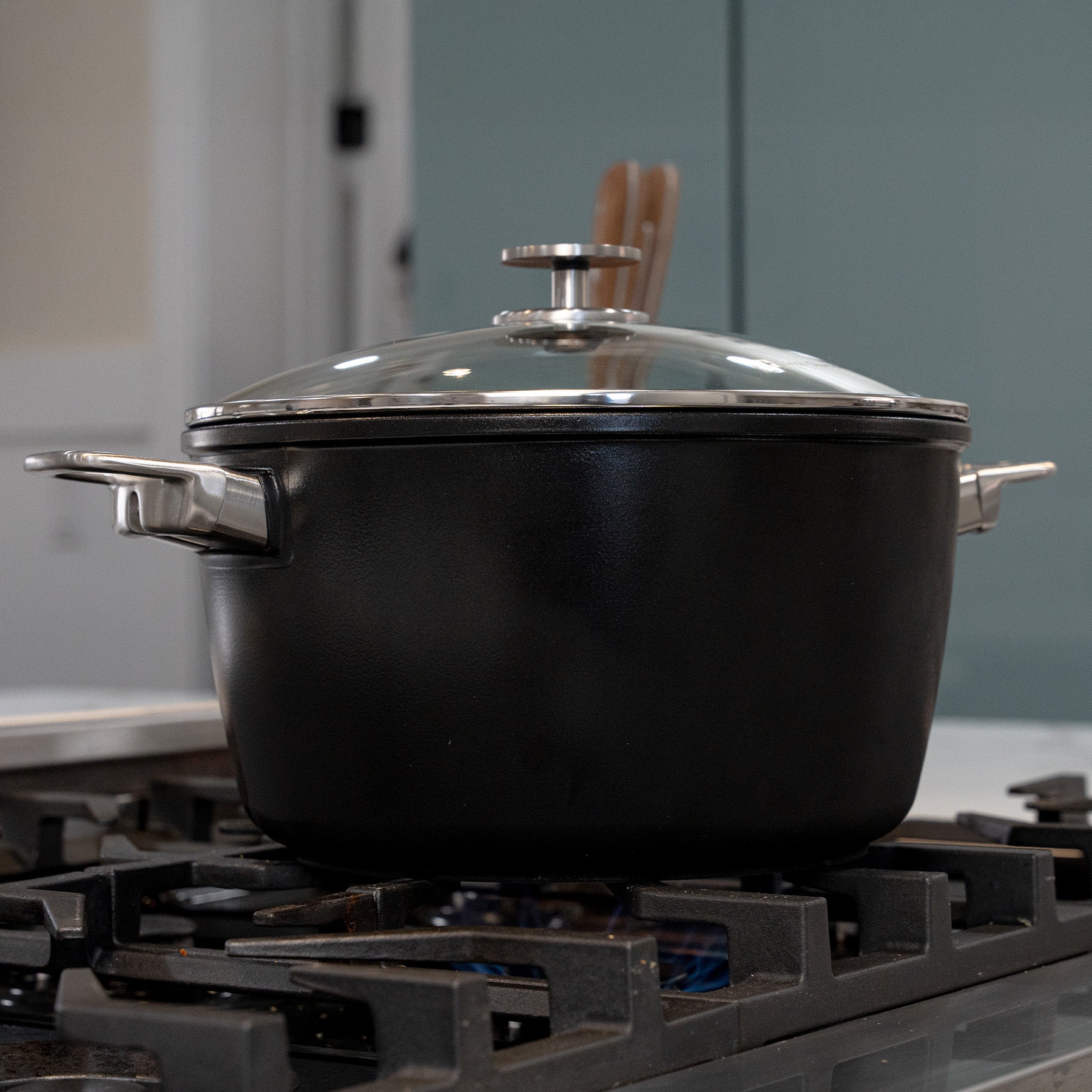 CHD Nonstick 8.5 qt Stock Pot with Glass Lid side view on a gas stove top