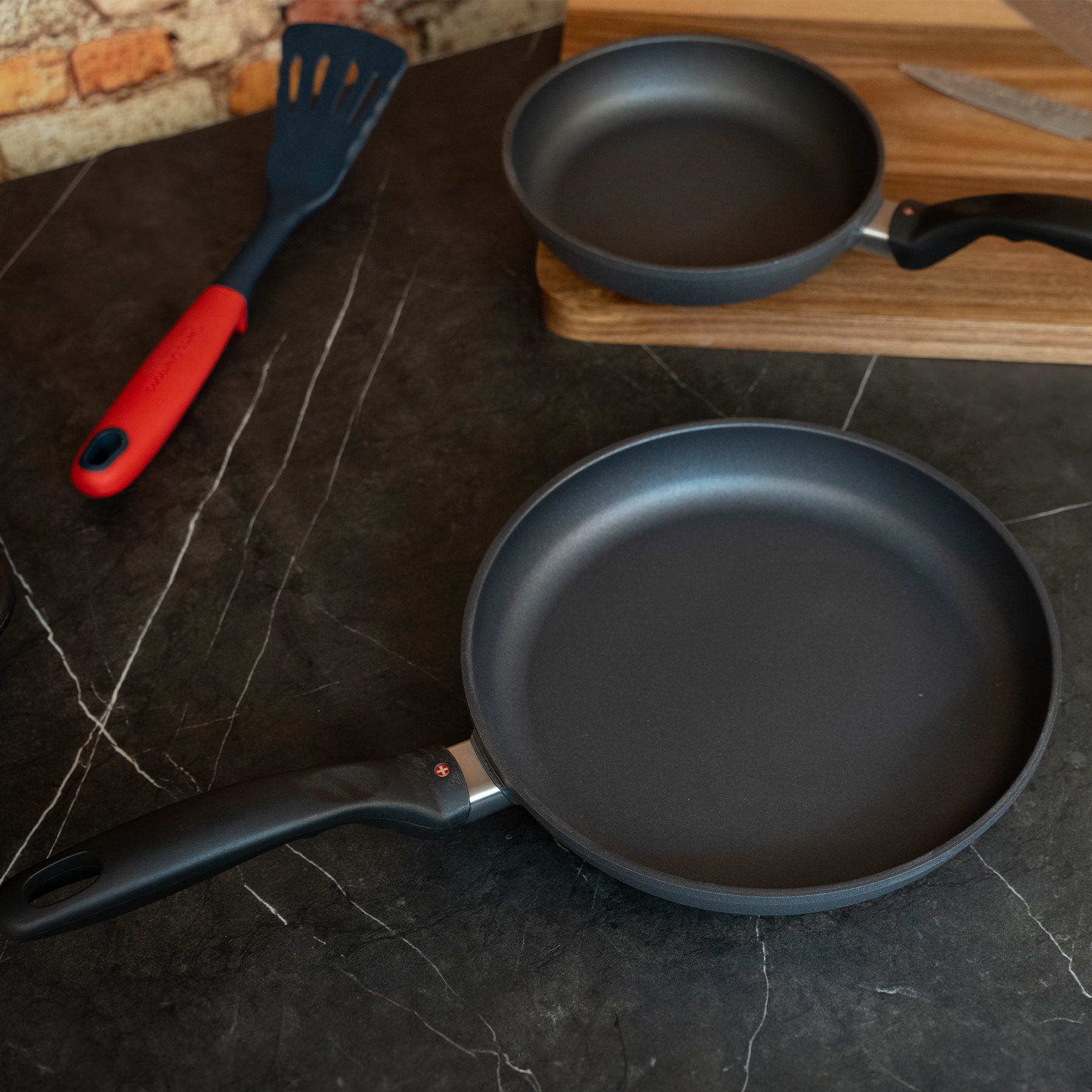 HD Nonstick 2-Piece Fry Pan Set - Induction in use on black granite kitchen counter