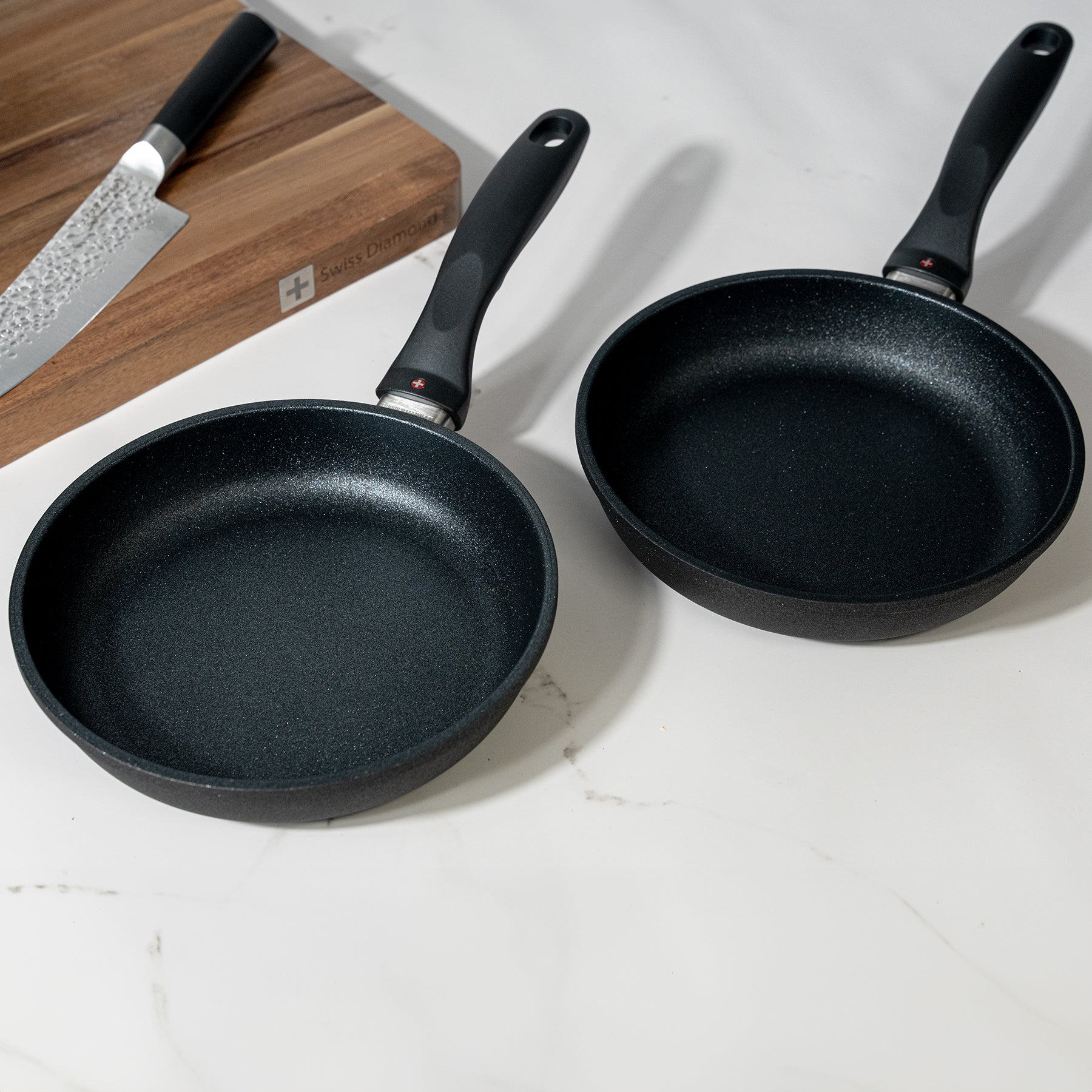 XD Nonstick 2-Piece 8" Fry Pan Set on kitchen counter beside a cutting board and knife