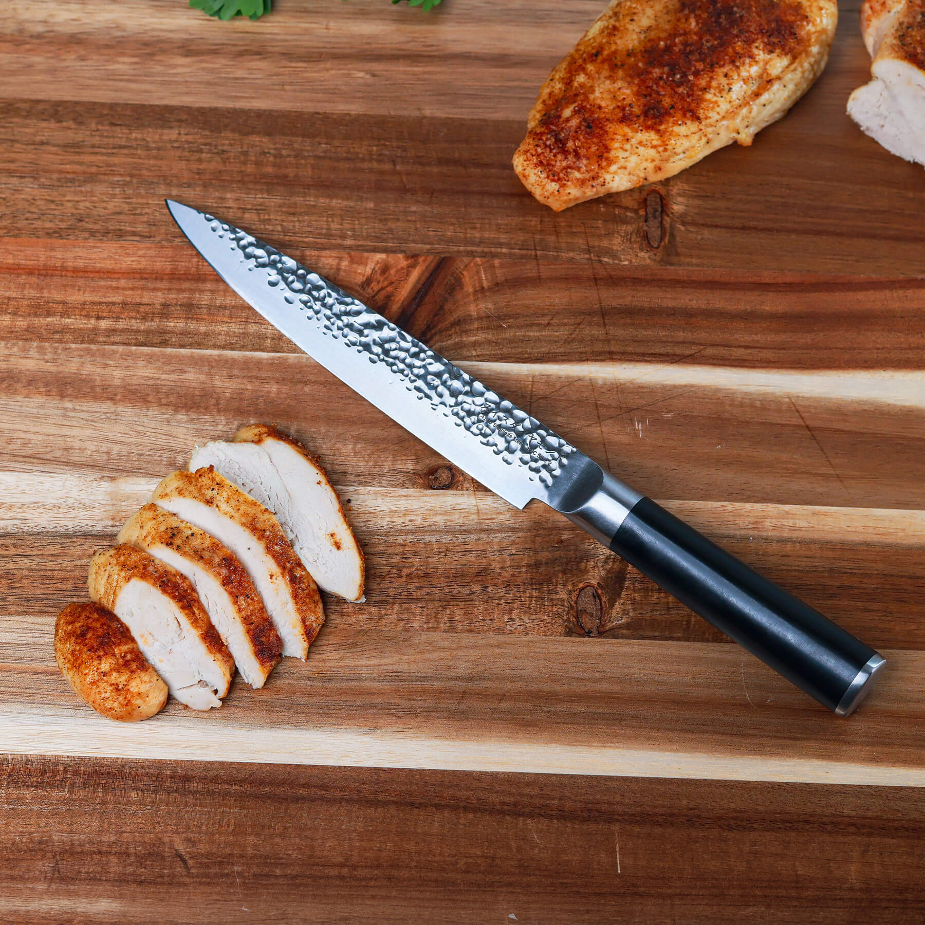 8" Hammered Carving Knife on cutting board with sliced chicken