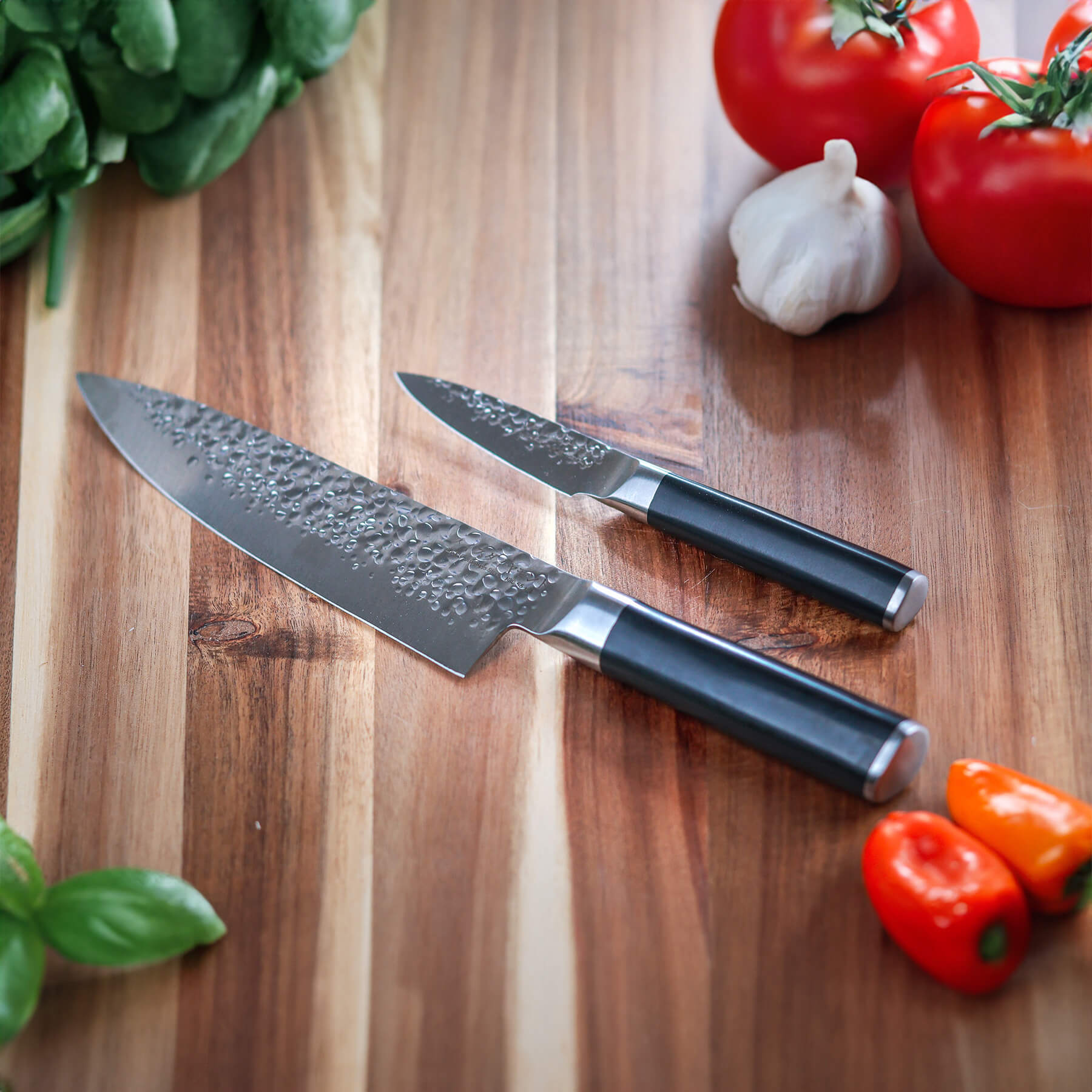 Hammered Chef Paring Set on wooden cutting board with food