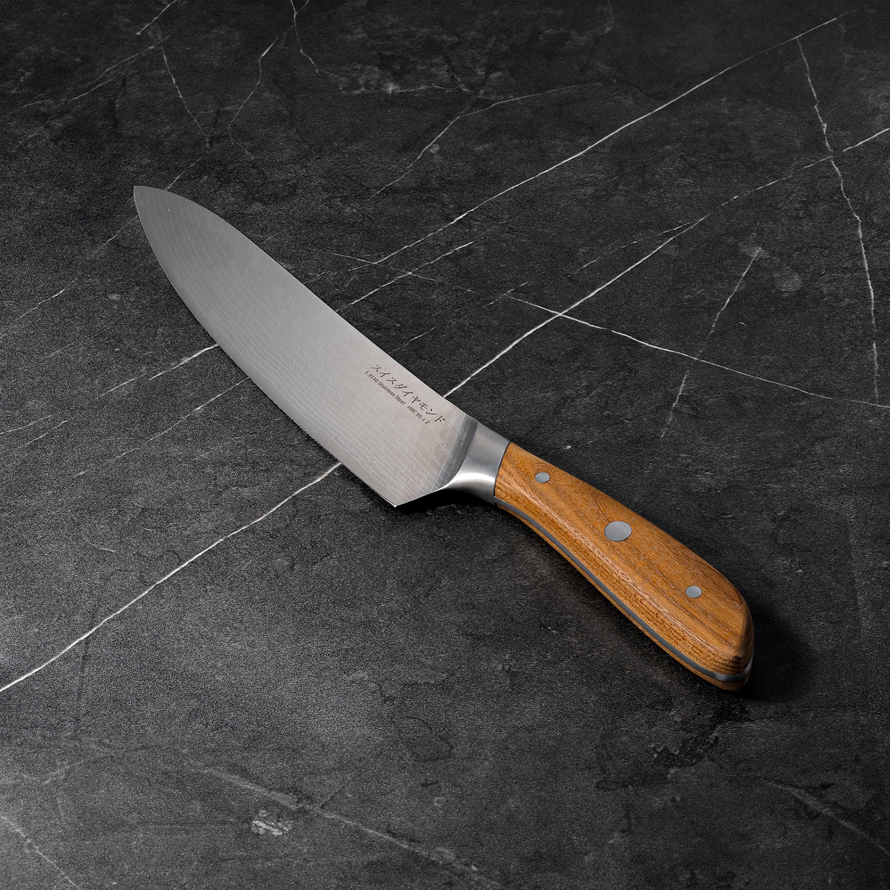 8" Damascus Chef Knife angled view on black marble kitchen counter