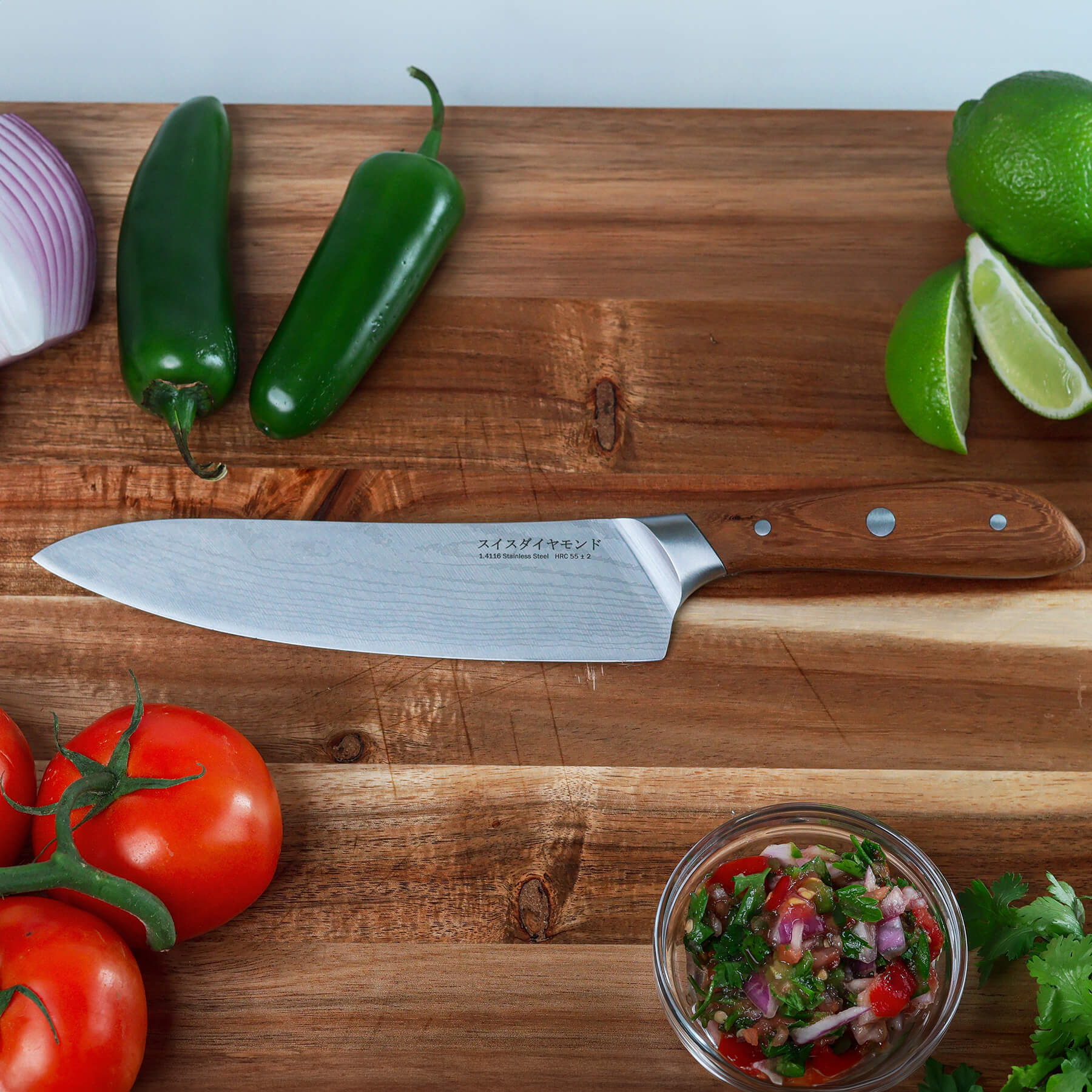 8" Damascus Chef Knife on cutting board with veggies and salsa on side
