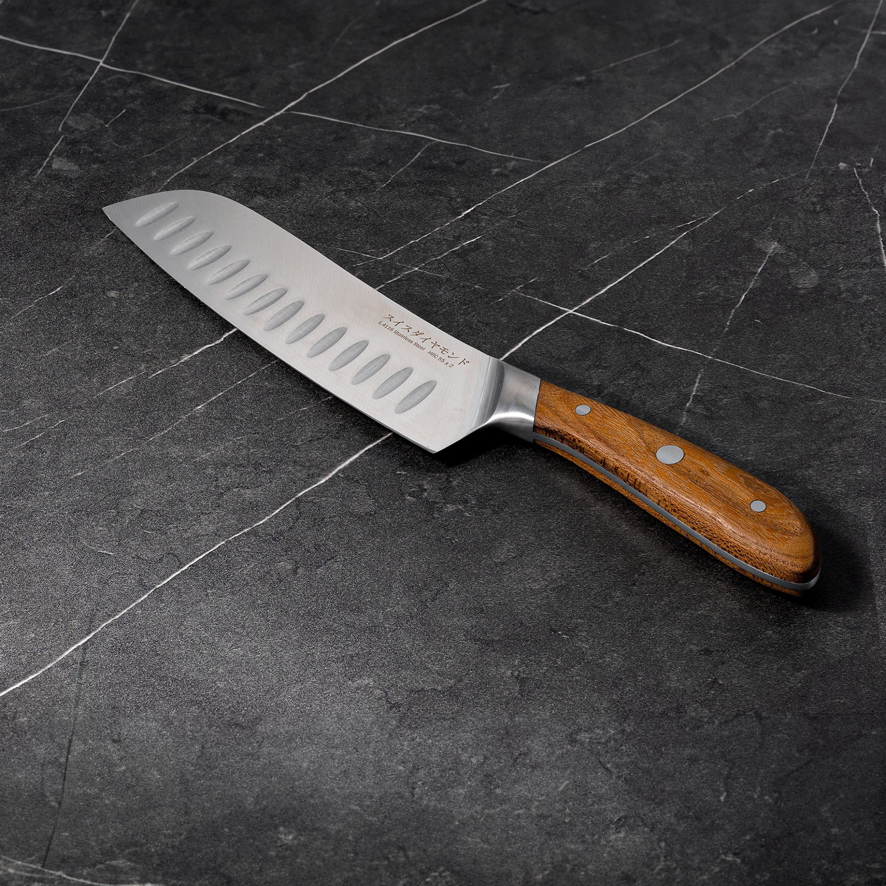 7" Damascus Santoku Knife angled view on black marble kitchen counter