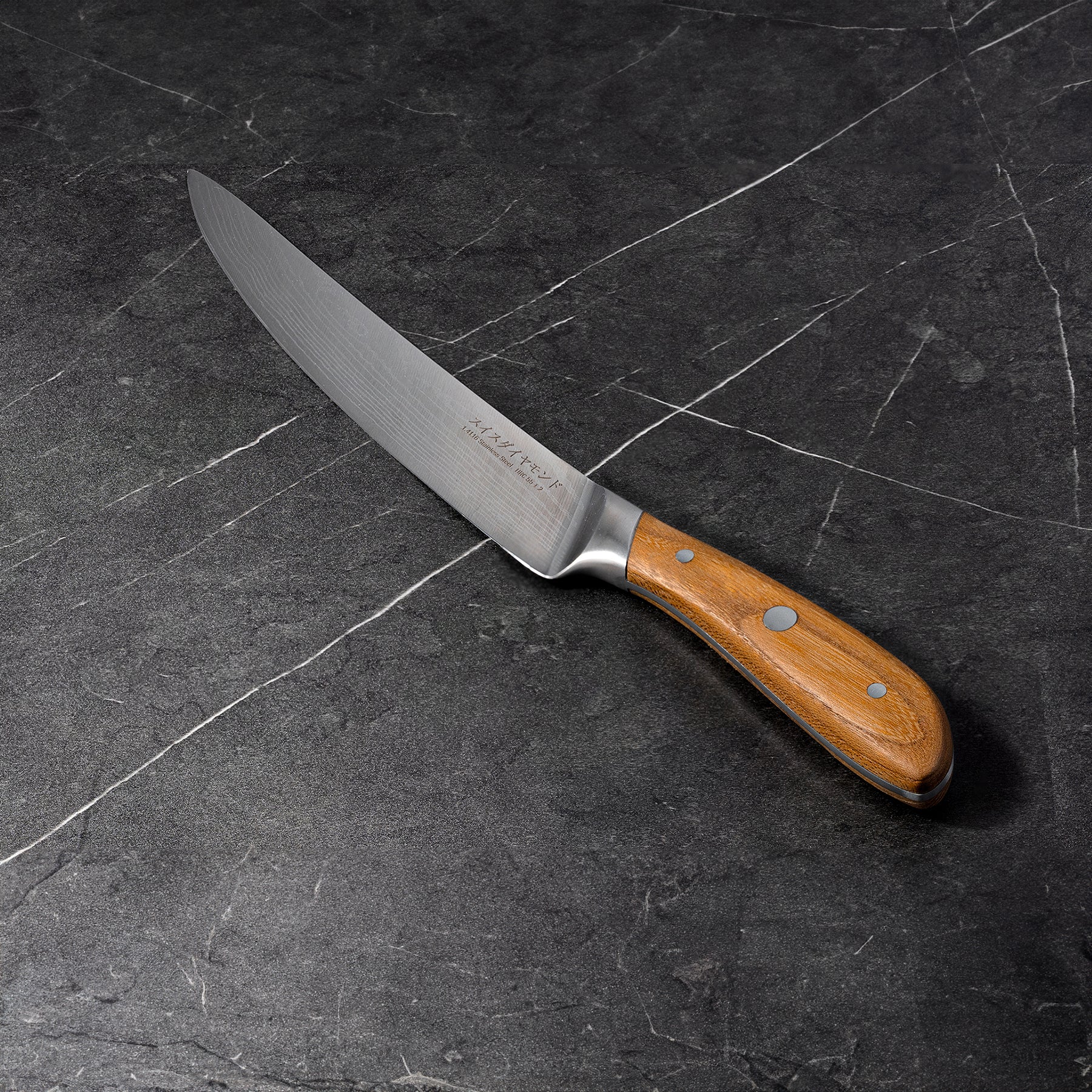 8" Damascus Carving Knife angled view on black kitchen counter