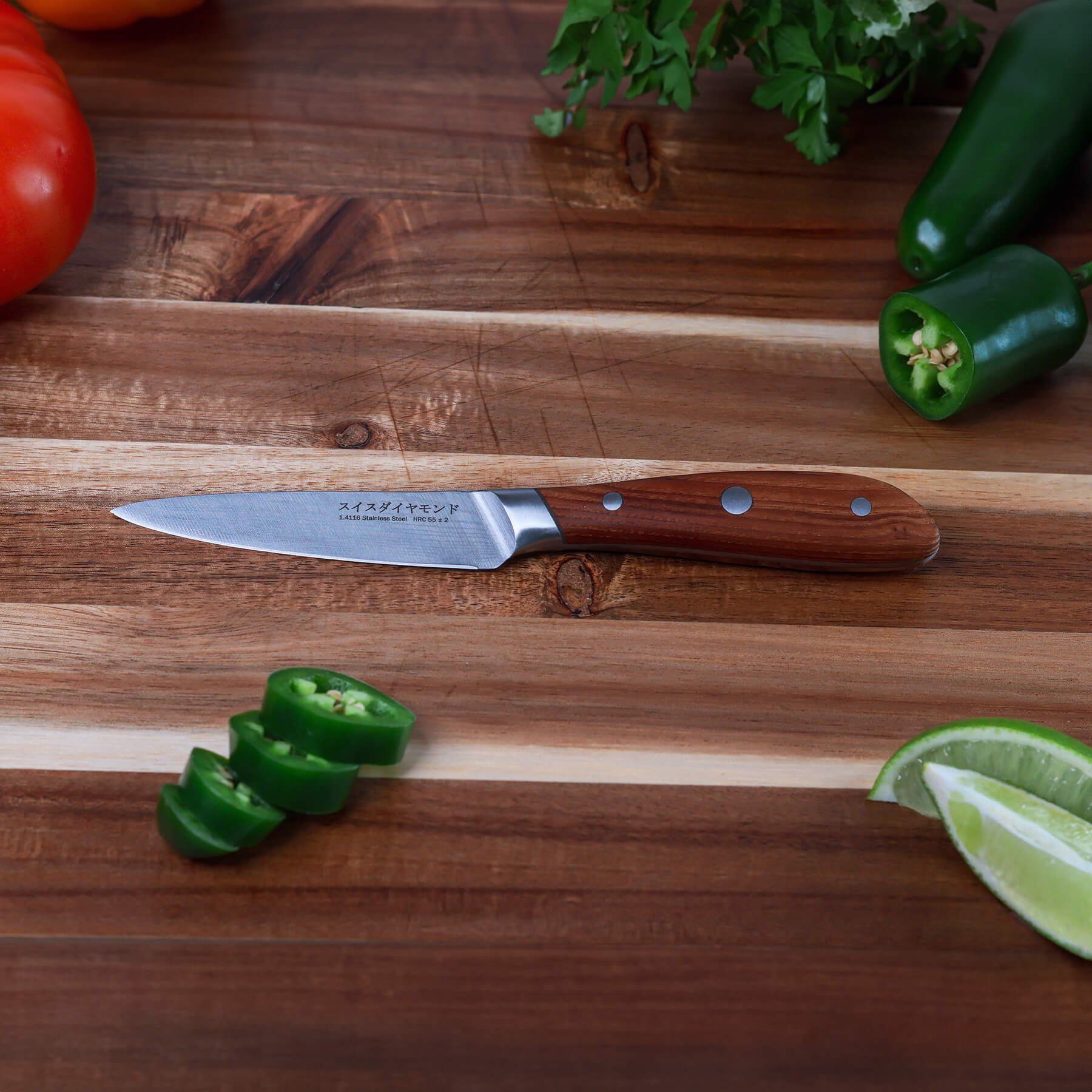 4" Damascus Paring Knife is on cutting board with sliced jalapenos 