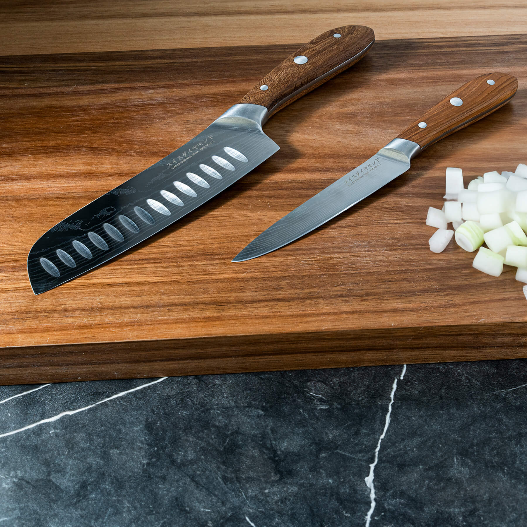 Damascus Santoku Paring Set on cutting board with wooden chopped food