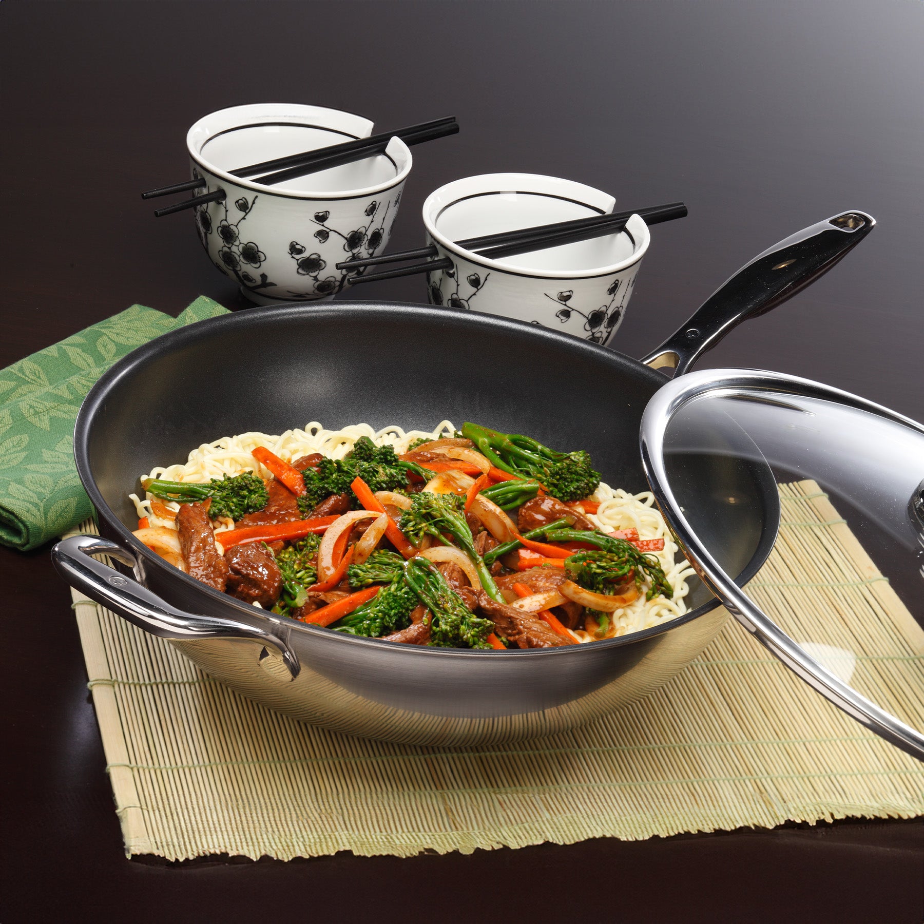 Nonstick Clad 12.5" Wok with Glass Lid - Induction in use on black kitchen counter