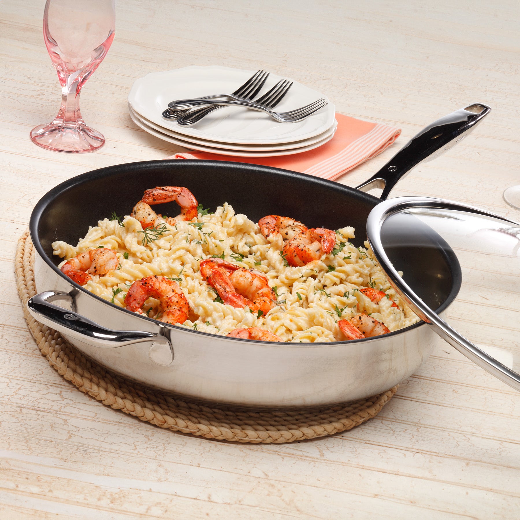 Nonstick Clad Saute Pan with Glass Lid - Induction in use on wooden table