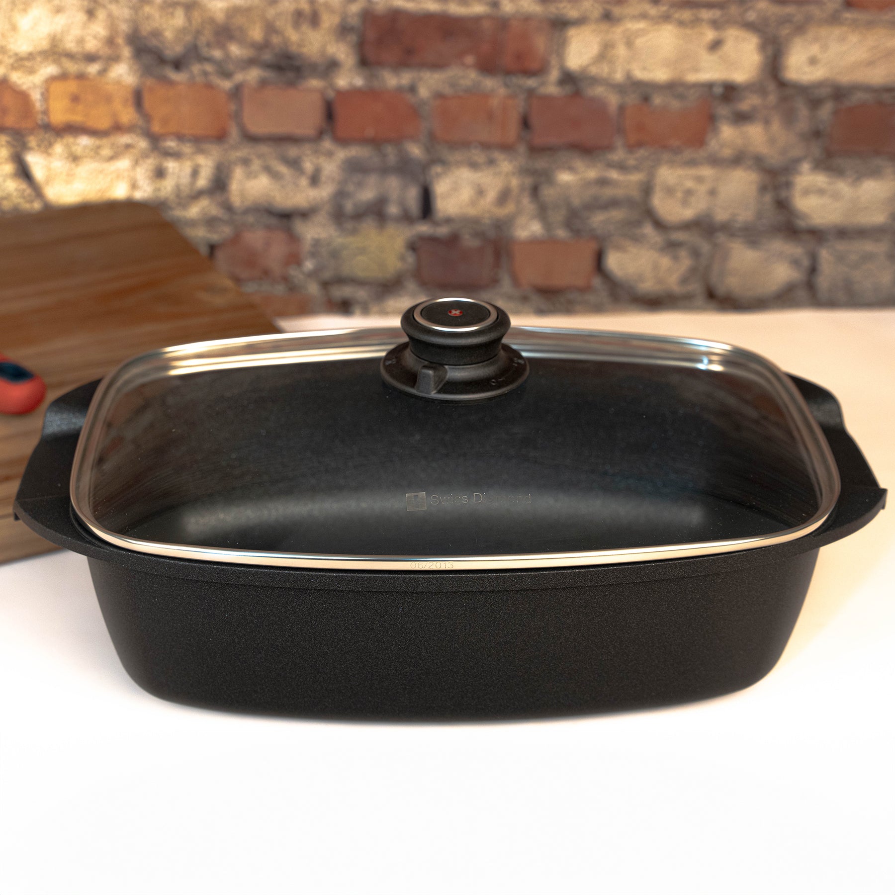 XD Nonstick 5.3 qt Roaster with Glass Lid side view on kitchen counter