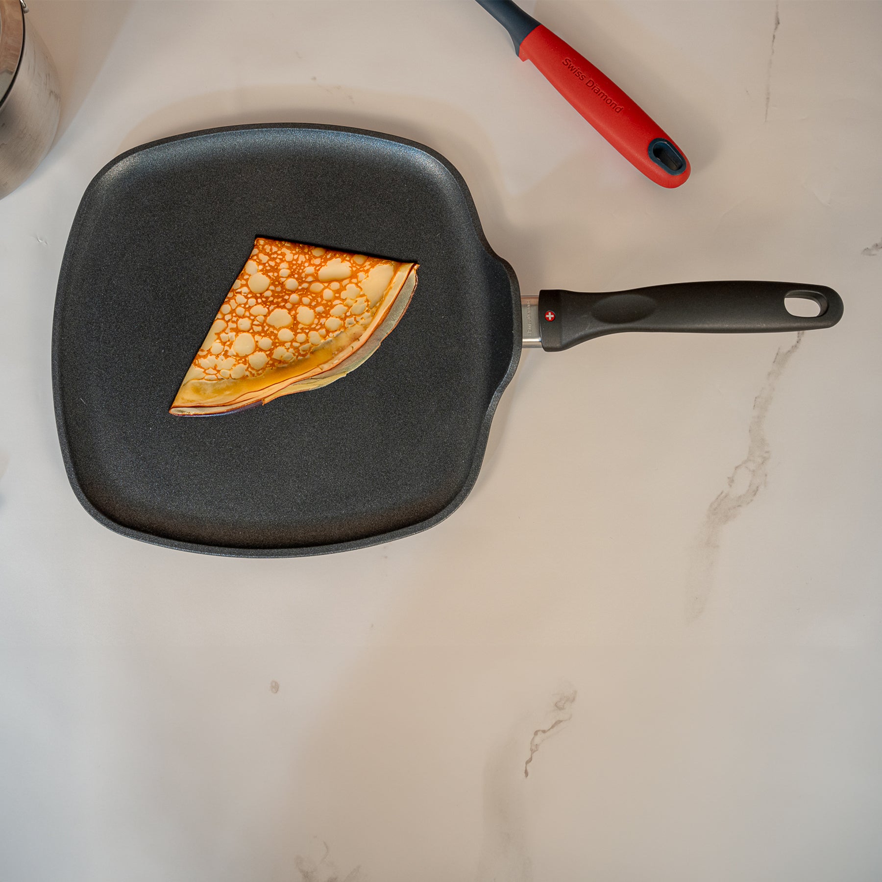 XD Nonstick 11" x 11" Square Griddle in use with folded crepe