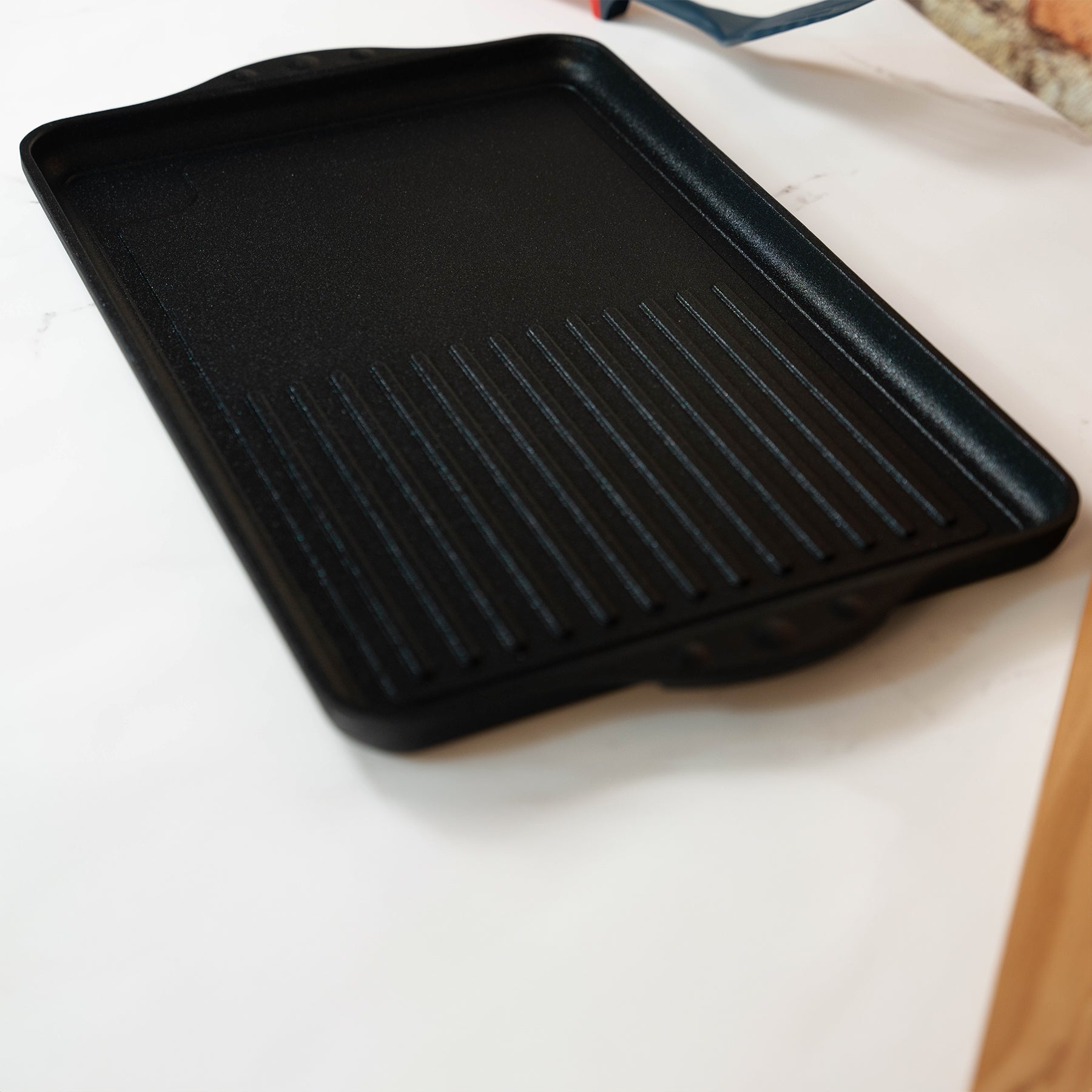 XD Nonstick 17" x 11" Double-Burner Grill/Griddle Combo in use on kitchen counter