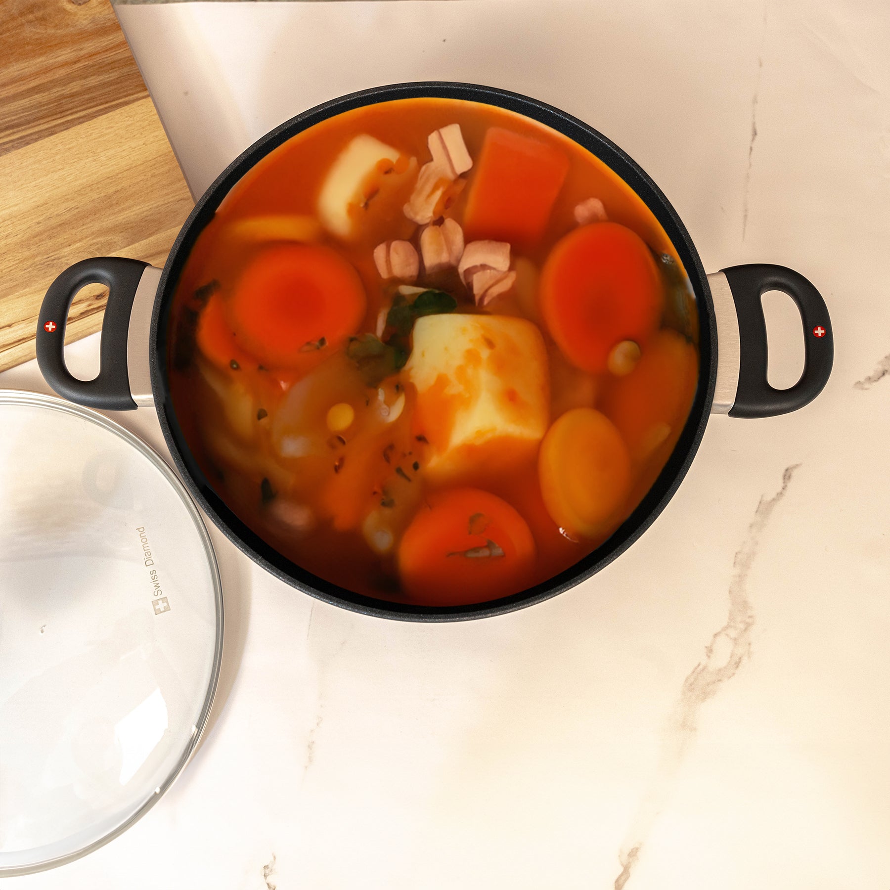 XD Nonstick Braiser with Glass Lid top view of food inside sitting on a marble kitchen counter