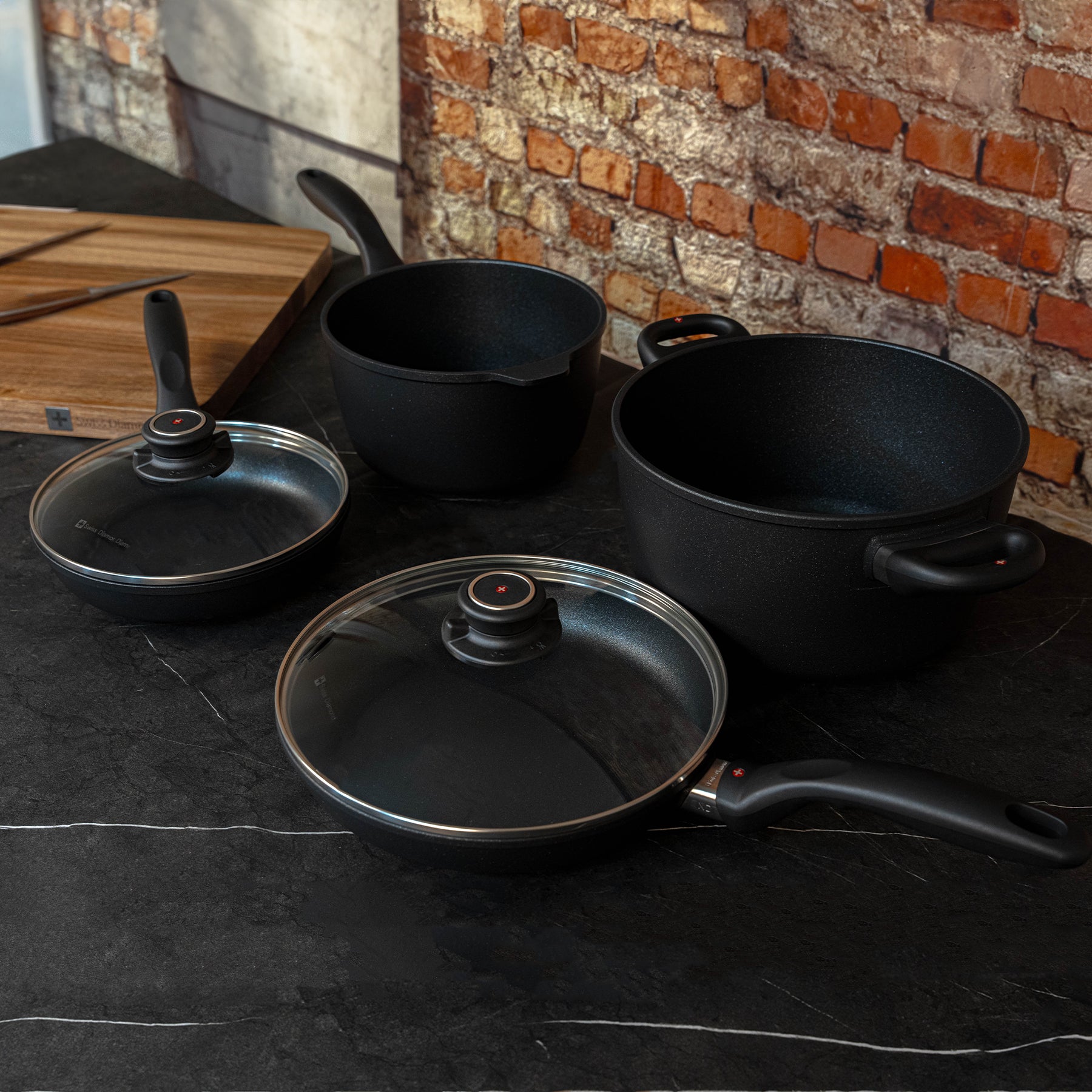 XD Nonstick 6-Piece Set - Fry Pan, Saucepan & Soup Pot - Induction top angled view on black marble counter top