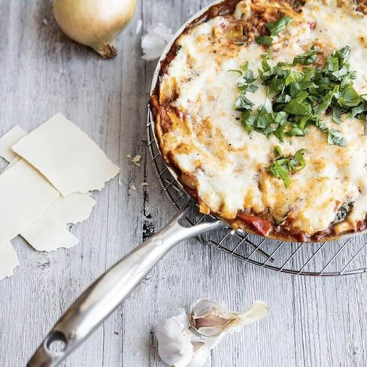 hd stainless steel fry pan in use on wooden table