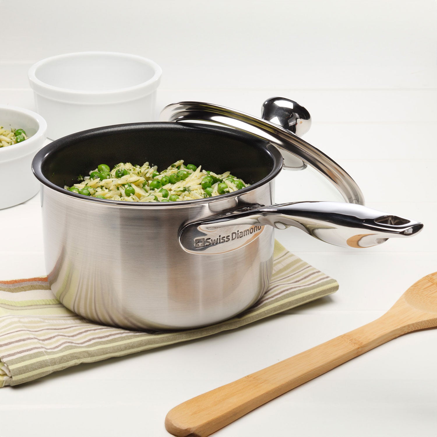 nonstick clad saucepan with glass lid and food inside