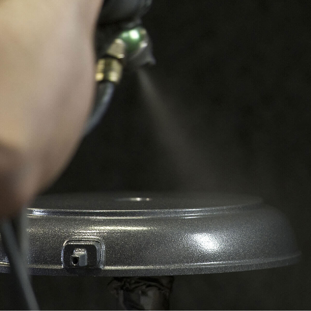 fry pan being coated with a nonstick formula