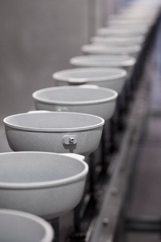 assembly line of uncoated fry pans