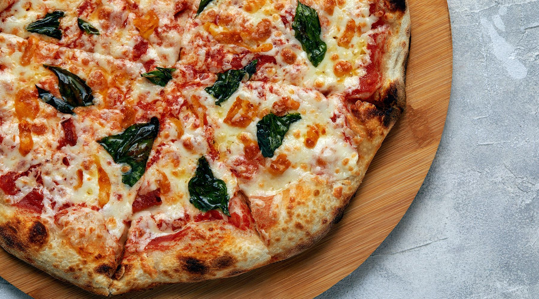 Pizza topped with bacon, basil, and caramelized onions