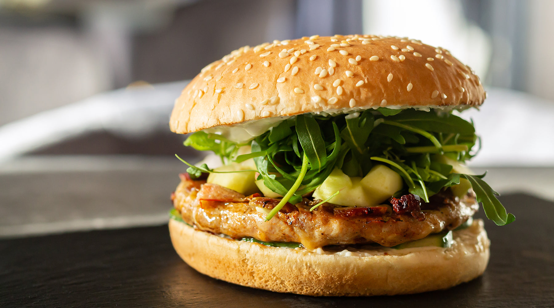 Apple Pork Burger on a dark table top 