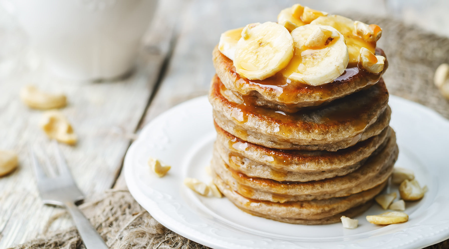 stack of pancakes topped with bananas