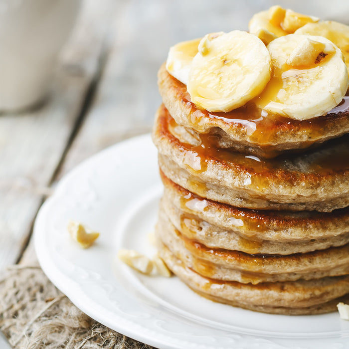 stack of pancakes topped with bananas