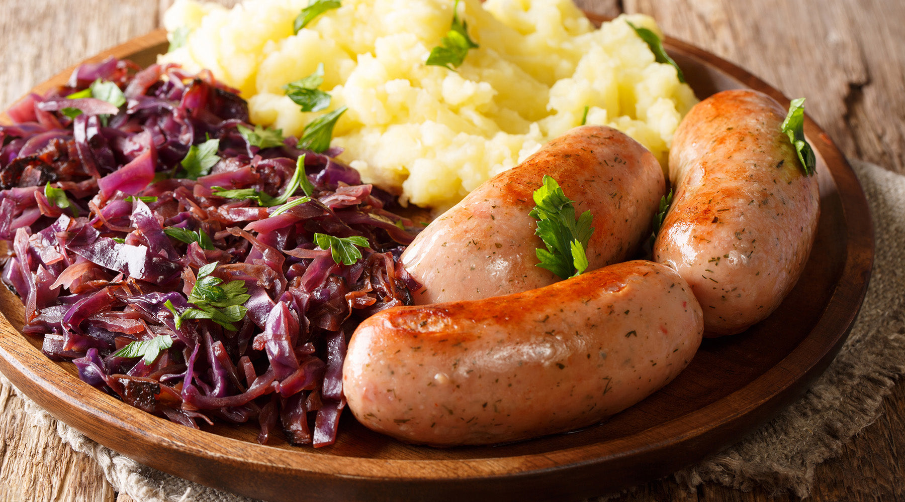 Bavarian red cabbage on a wood plate with sausage