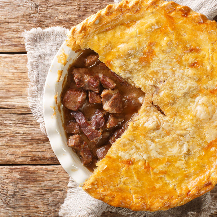 Beef Pie sitting on a wooden table