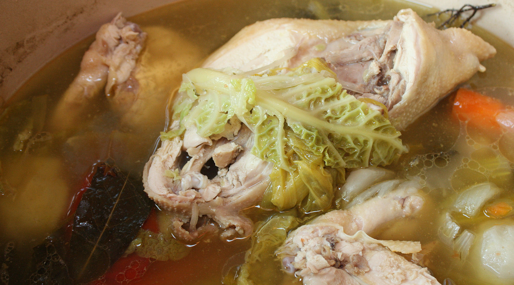 Braised chicken in a stock pot