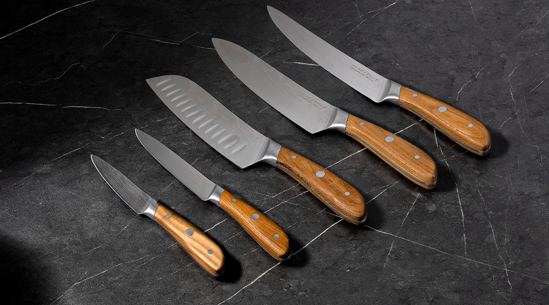 Knives laid out side by side on counter top