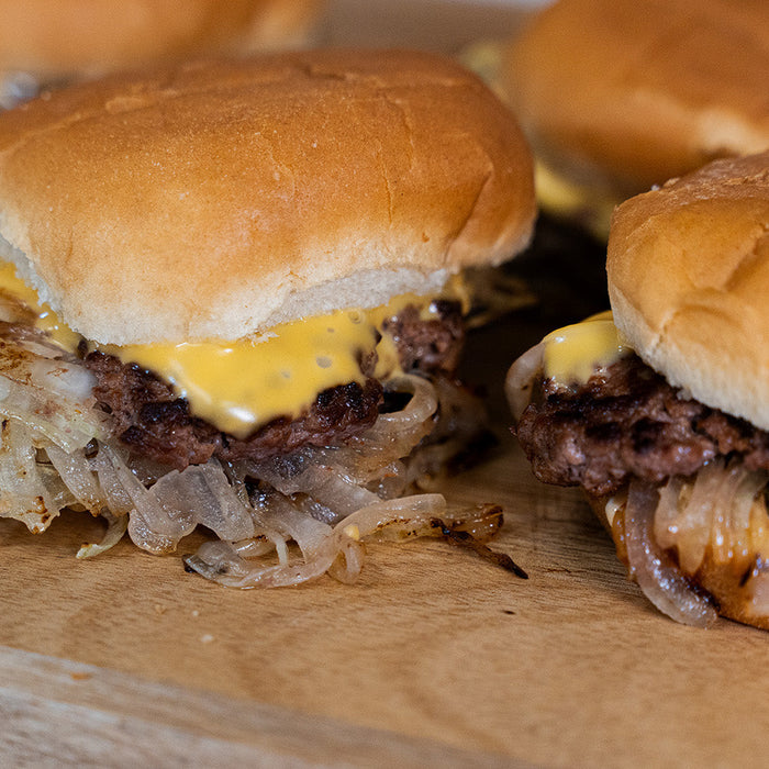 Smash burgers on a cutting board