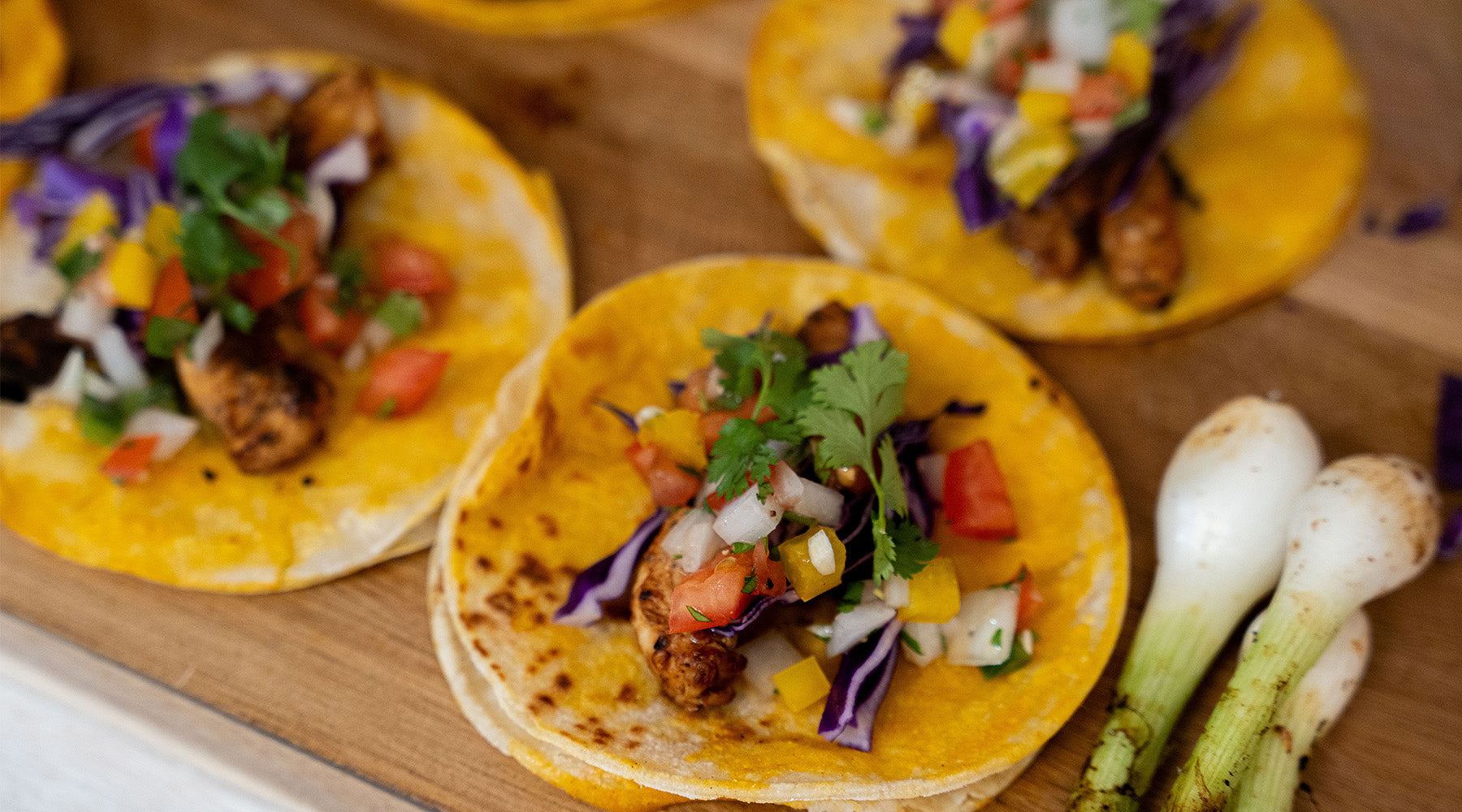 chicken tacos on a wood cutting board