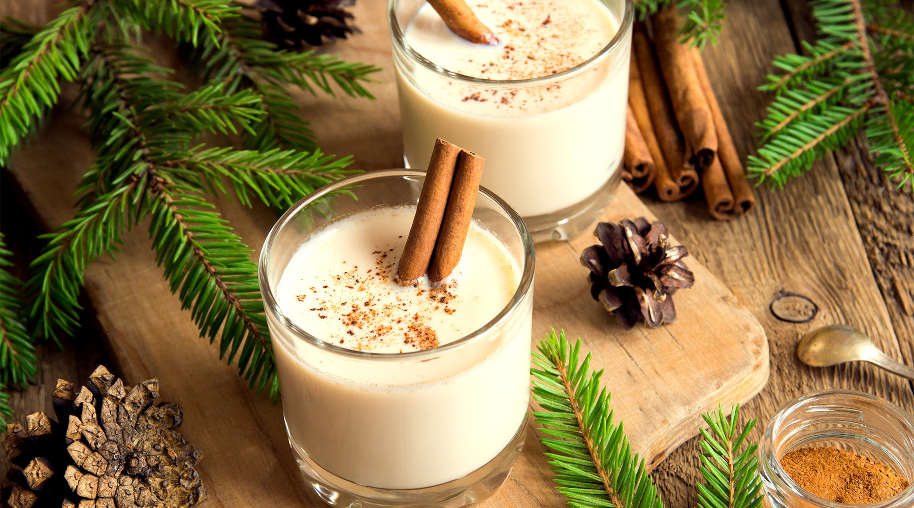 Eggnog in a glass on a table with holiday decorations