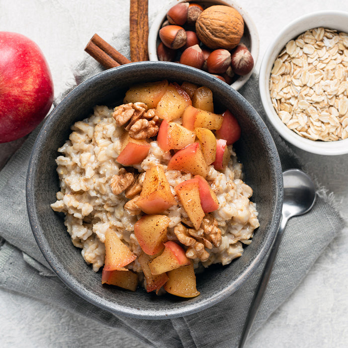 Overnight Apple Pie Steel Cut Oatmeal on Counter surrounded by toppings