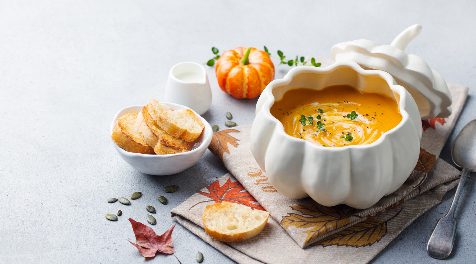 Sweet potato chili in a bowl surrounded by fall decorations