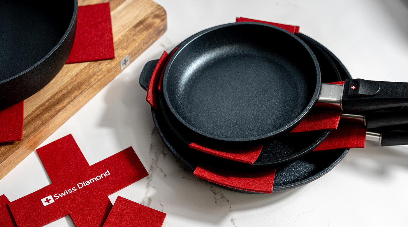 cookware accessories including felt pan protectors in use and cutting board on kitchen counter