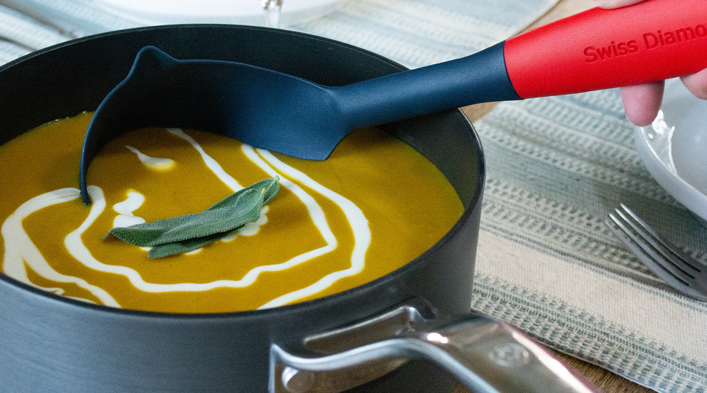 ladle kitchen tool scooping out food from inside a sauce pot