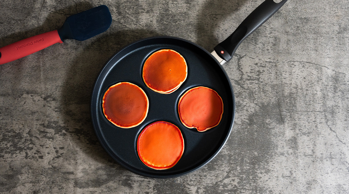 Breakfast Pans with food inside and on a marble gray kitchen countertop