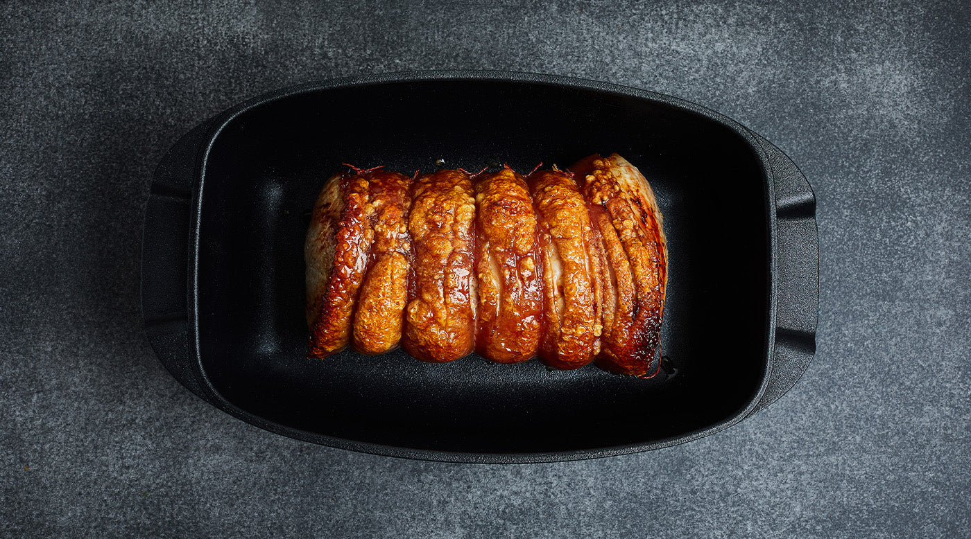 roasters or bakeware with food inside top view on kitchen counter