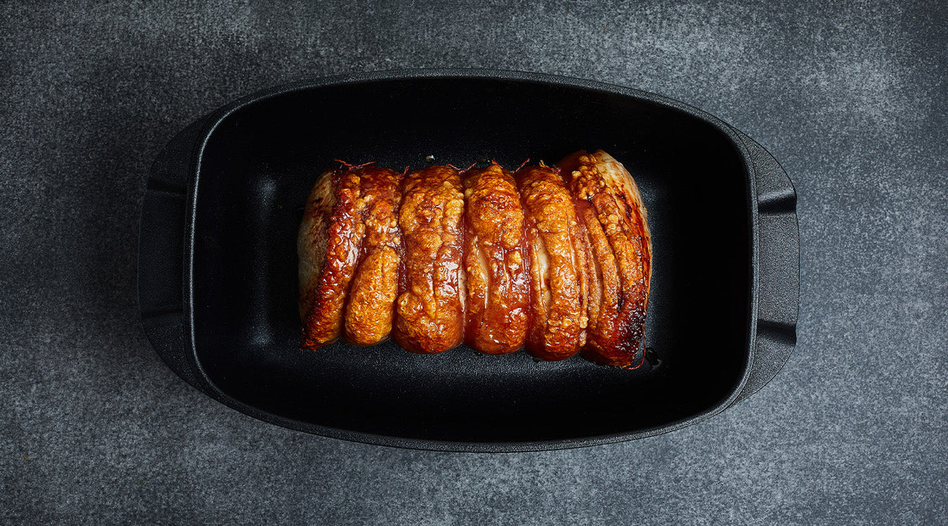 roasters or bakeware with food inside top view on kitchen counter