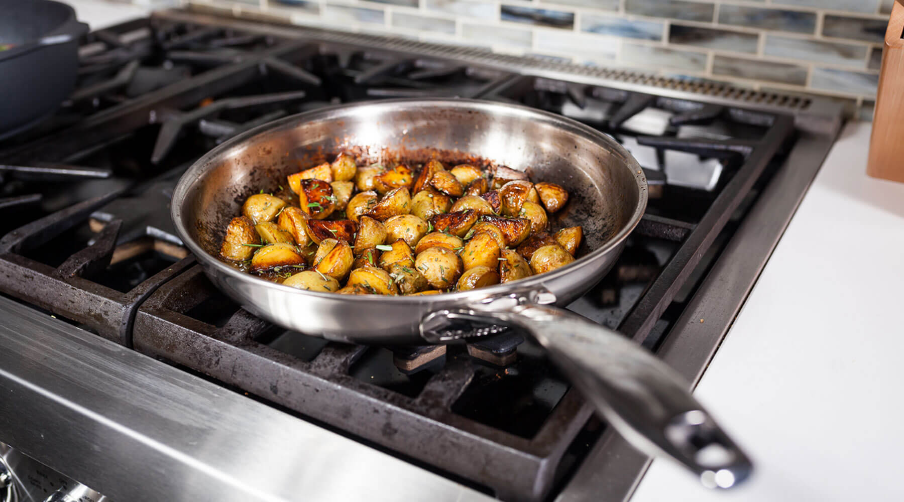stainless steel fry pan cooking food on stove