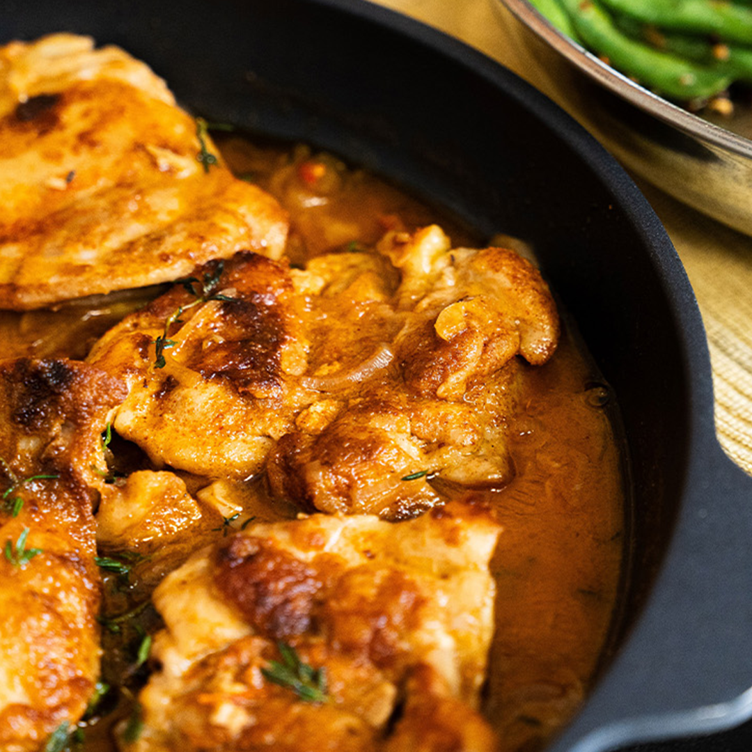 HD Classic Nonstick with food inside on a dining room table